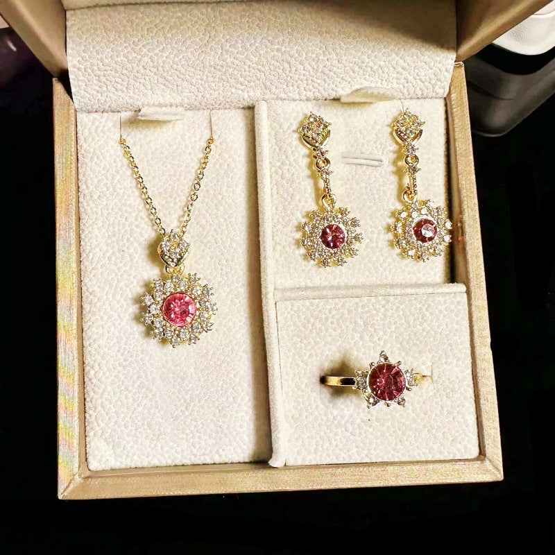 Women's Pomegranate Red Rings Pendants Earings Set displayed with necklace, earrings, and ring in gold and red design.