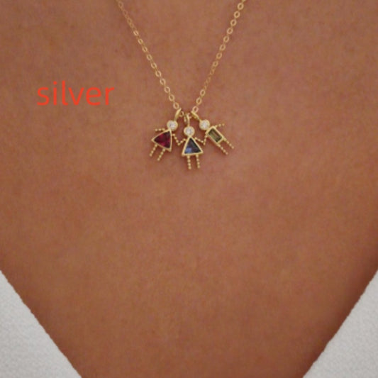 Twelve zodiac stone pendants in gold featuring colorful girl figures on a chain necklace.