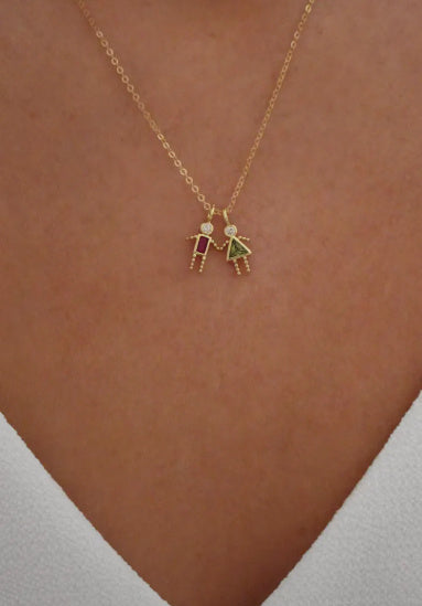 Twelve zodiac stone pendants in gold featuring colorful girl figures on a chain necklace.