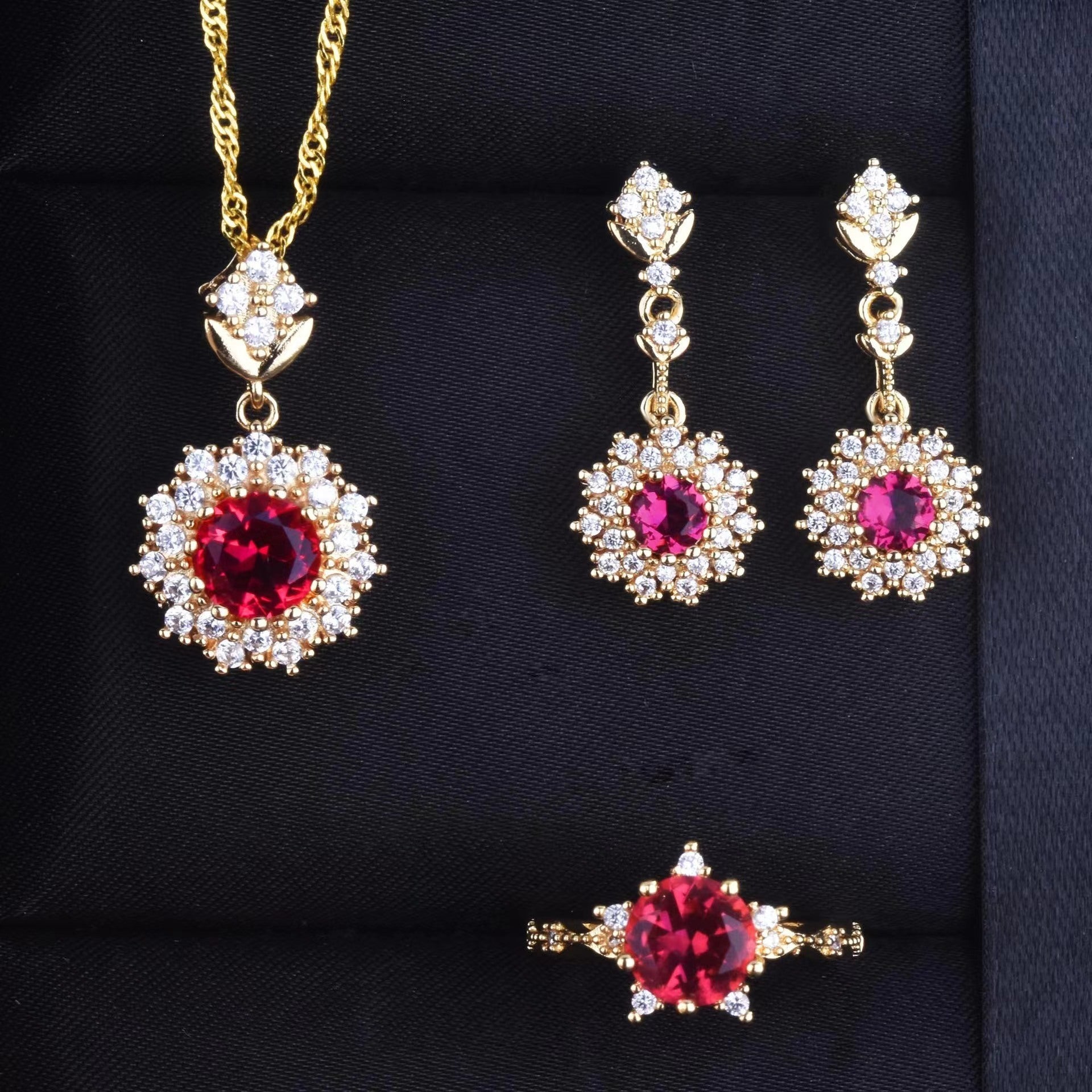 Women's Pomegranate Red Rings Pendants Earings Set displayed with necklace, earrings, and ring in gold and red design.
